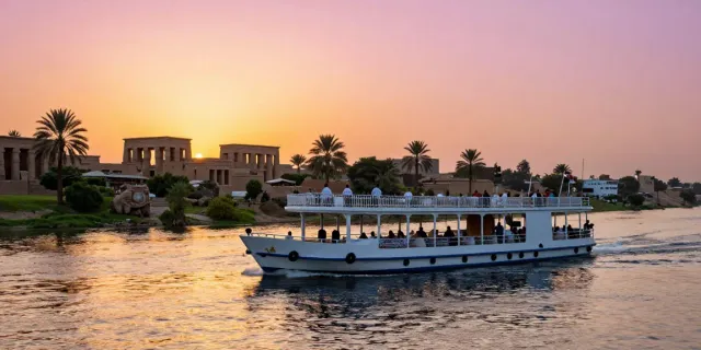 Dahabiya Nile cruises offer luxurious sailing experiences with stunning views of temples and lush landscapes at sunset.